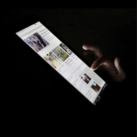 Palma de Mallorca, Spain - August 28, 2016 - Using a tablet to check daily news in a technological companies meeting in the island of mallorcaのeditorial素材