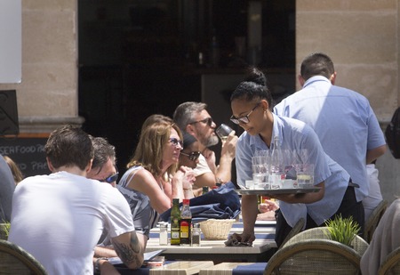 Palma de Mallorca, Spain - May 9, 2018 - Crowded terraces during the beginning of the summer touristic season in the Spanish island of Mallorca. High amount of employment due to tourism pushes the Balearic islands economy between the 4 main in Spainのeditorial素材