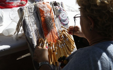 Esporles Mallorca, Spain - October 7, 2018 - Bobbin lace weaver woman showing her traditional handmade technique during a local fair in the village of Esporles in the Spanish island of Mallorca.のeditorial素材