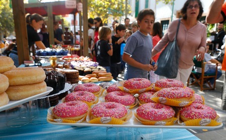 Esporles Mallorca, Spain - October 14, 2018 - Visitors walk near the bakery stands during the Fira Dolca local gastronomy fair in the village of Esporles in the Spanish island of Mallorcaのeditorial素材