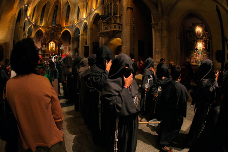 Palma de Mallorca, Spain - April 17 2019 - Penitents take part in the procession of Saint christ of...