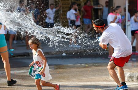 Santa Maria, Mallorca / Spain - July 20, 2019: Locals enjoy the traditional summer festivities including a global water battle between the youngest villagers of Santa Maria, central area of the Spanish island of Mallorcaのeditorial素材