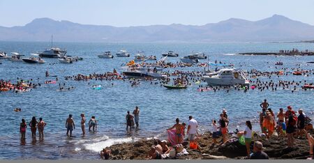 Can Picafort, Mallorca / Spain - August 15, 2019: People enjoy a traditional rubber ducks throw in...