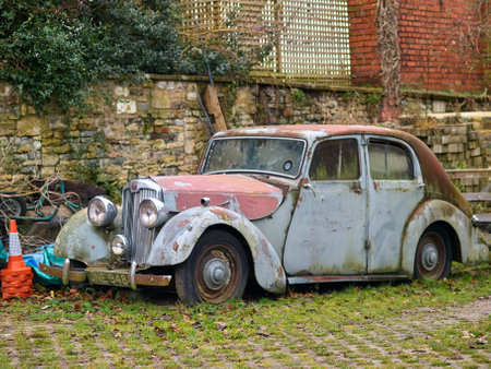 Old rusty car on the street of a small village in England.の写真素材