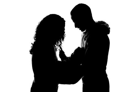 Silhouette of a young couple in love on a white backgroundの写真素材