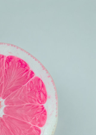 Grapefruit cut in half on a gray background.の写真素材