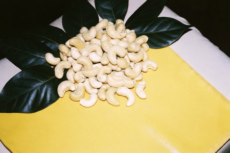 Cashew nuts on a yellow background. Cashew nuts on a yellow background.の写真素材