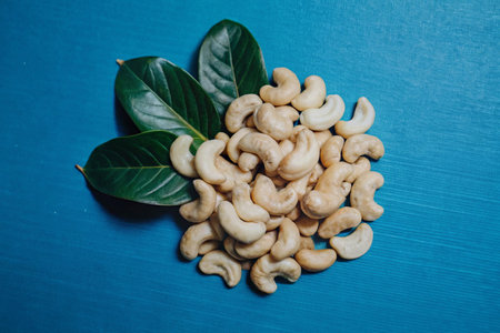 Cashew nuts on a blue background. Cashew nuts on a blue background.の写真素材