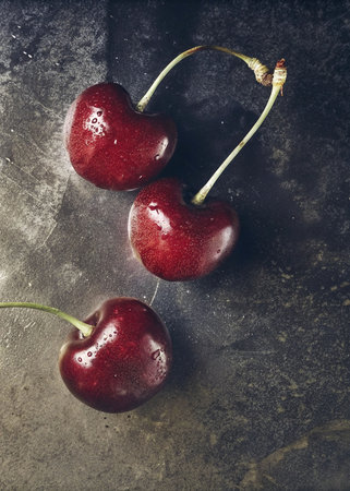 Ripe red cherries on a dark background. Toned.の写真素材