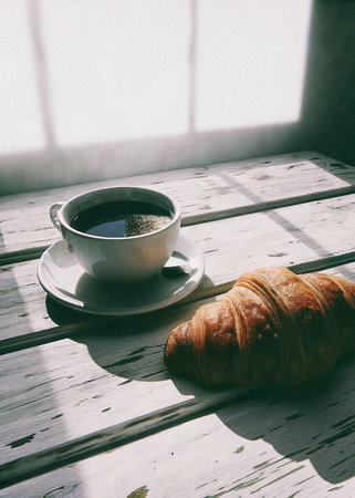 Coffee and croissant on the table in the morning.の写真素材