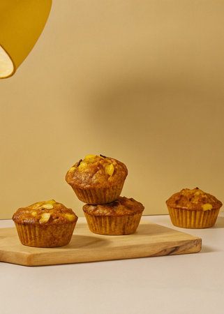 Muffins with almonds on a wooden board