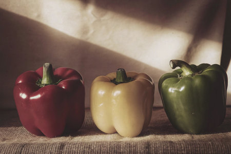 Three sweet peppers on sackcloth. Selective focus. Toned.の写真素材