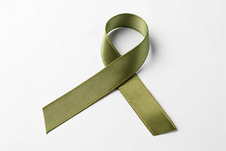 Green ribbon on white background, symbolic photo for awareness of prostate cancerの素材