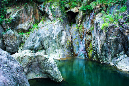 pond with rocks surroundedの写真素材