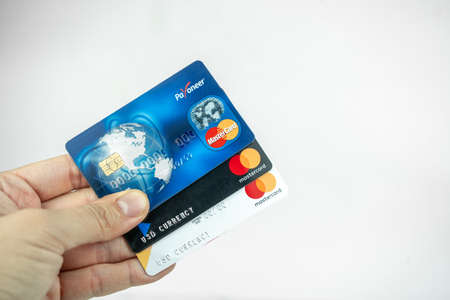 Set of Payoneer cards in a hand. Debit cards, money transfer concept. Kiev, Ukraine - August, 2020のeditorial素材