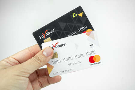 Set of Payoneer cards in a hand. Debit cards, money transfer concept. Kiev, Ukraine - August, 2020のeditorial素材