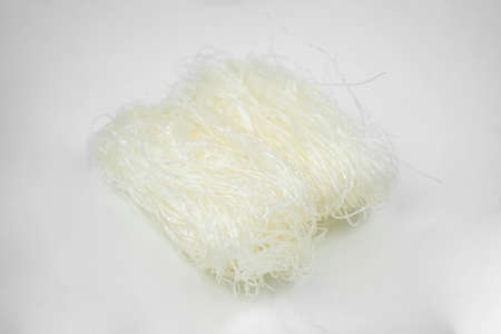 uncooked dry glass noodle, white bean asian vermicelli, rice noodles, isolated on white