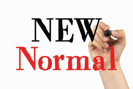 New normal phrase on a whiteboard, written with black and red marker in a hand.
