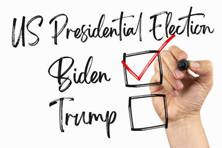 Vote for new president, US elections 2020 with checkbox. Doodle on a whiteboard, written with black marker in a hand. Scribble sketch text on a white boardの写真素材