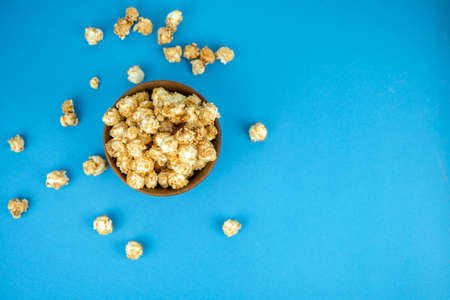 wooden bowl of fresh popcorn with caramel