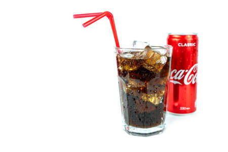 glass of cold refreshing coca cola soda with ice, metal can of coca cola classic, isolated on whiteのeditorial素材