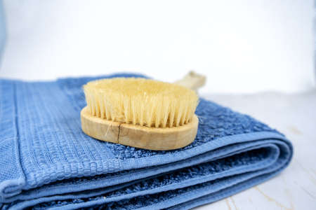 Skincare or body massage procedures concept. Set of wooden brush and towel to take a bath.の写真素材