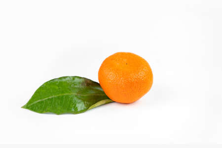 Ripe fresh juicy tangerines with leaves on white background