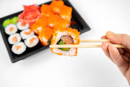take away sushi rolls in plastic container, california, salmon maki roll, pink ginger, wasabi. sushi...