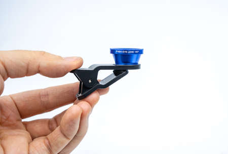 Phone photo lens with clips on white background. Extra macro camera for smartphone. Set of lenses wide angle, fish eye and macroの写真素材