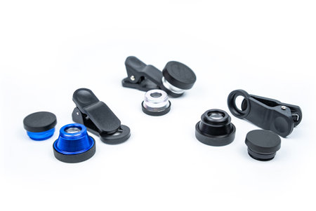 Phone photo lens with clips on white background. Extra macro camera for smartphone. Set of lenses...