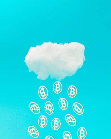 Bitcoins falling from the cloud on blue background. Mining or blockchain technology for cryptocurrency concept. Advertisement idea. Abstract ad 3D illustration.の写真素材