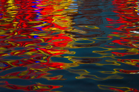 A gradual change of red, yellow and blue color of waterの写真素材