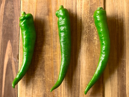 close up of green chilies on tableの写真素材