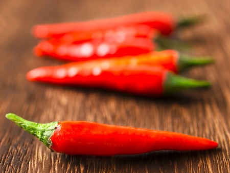 close up of red chili padi on table