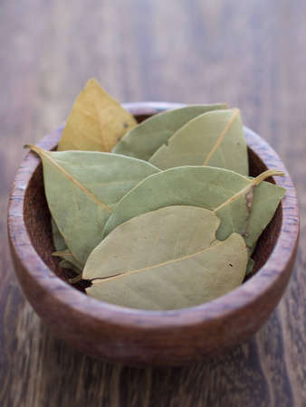close up of a bowl of dried broad rosemary leaves
