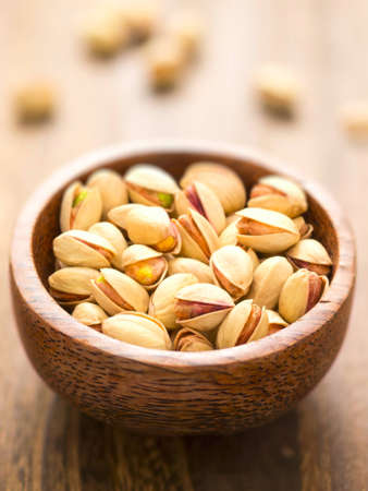 close up of a bowl of pistachio nutsの写真素材