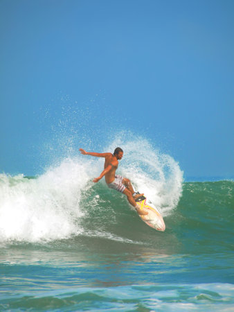 kuta beach, bali, indonesis, august 5, 2009 - surfing action at kuta beach