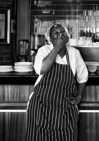 gaborone, botswana - November 17 2013 : shy, smilling, news cafe restaurant chef taking a break.のeditorial素材
