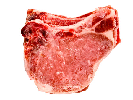 close up of frozen pork chops isolatedの写真素材