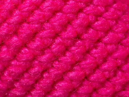 close up of neon pink fabric material texture background
