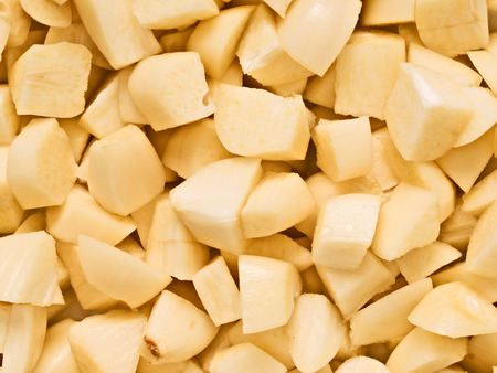 close up of chunky chopped uncooked raw garlic food backgroundの写真素材