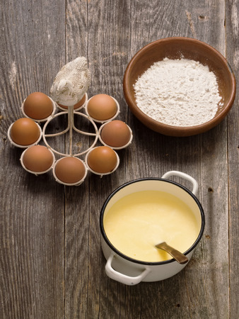 close up of a pot of creamy custard sauce, egg and flourの写真素材