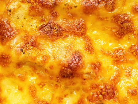 close up of golden lasagna baked cheese crust food backgroundの写真素材