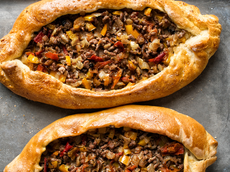 close up of rustic golden turkish pide bread pizzaの写真素材