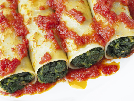close up of rustic italian vegetarian spinach cannelloni pastaの写真素材