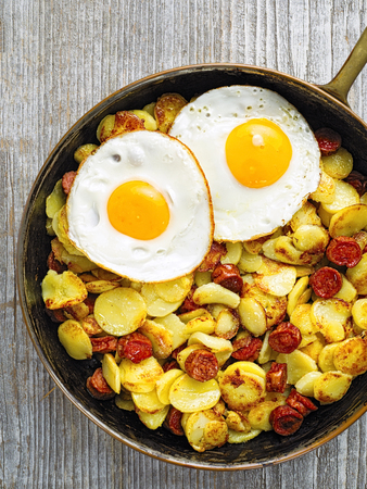 close up of a pan of rustic sausage potato hashの写真素材