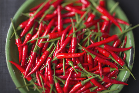 close up of rustic red bird eye chilies defocused