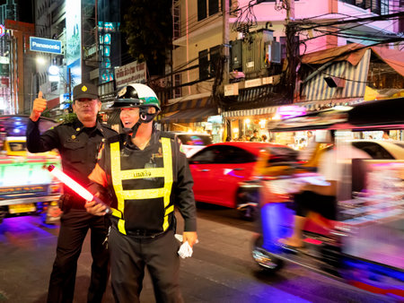 Bangkok, Thailand, 3rd January 2019, Friendly police in Bangkok Chinatown at night. They help regulate traffic to ease the terrible traffic jams.のeditorial素材