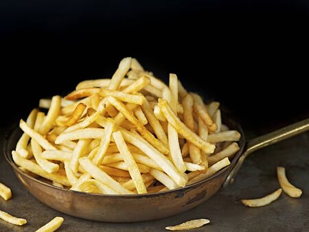 close up of pan of rustic golden french friesの写真素材