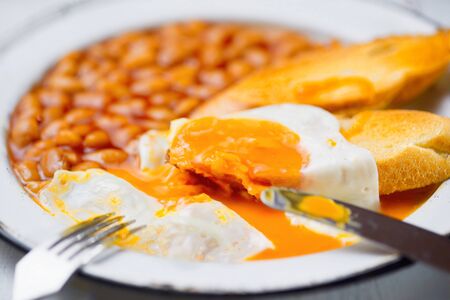 closed up of rustic english baked beans egg toast breakfast